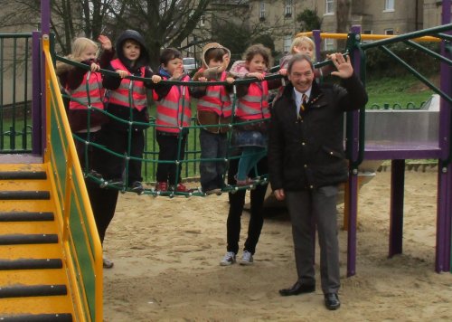 Children on rope bridge with Councillor waving