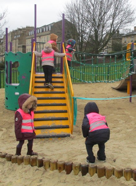 Children on sand and ramp in play area