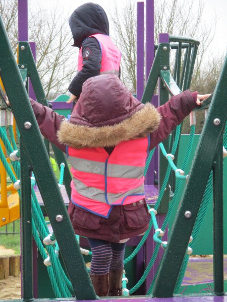 Child on roper bridge hood hding face