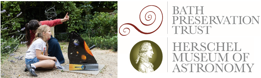 Two children looking at a sculpture of the solar system