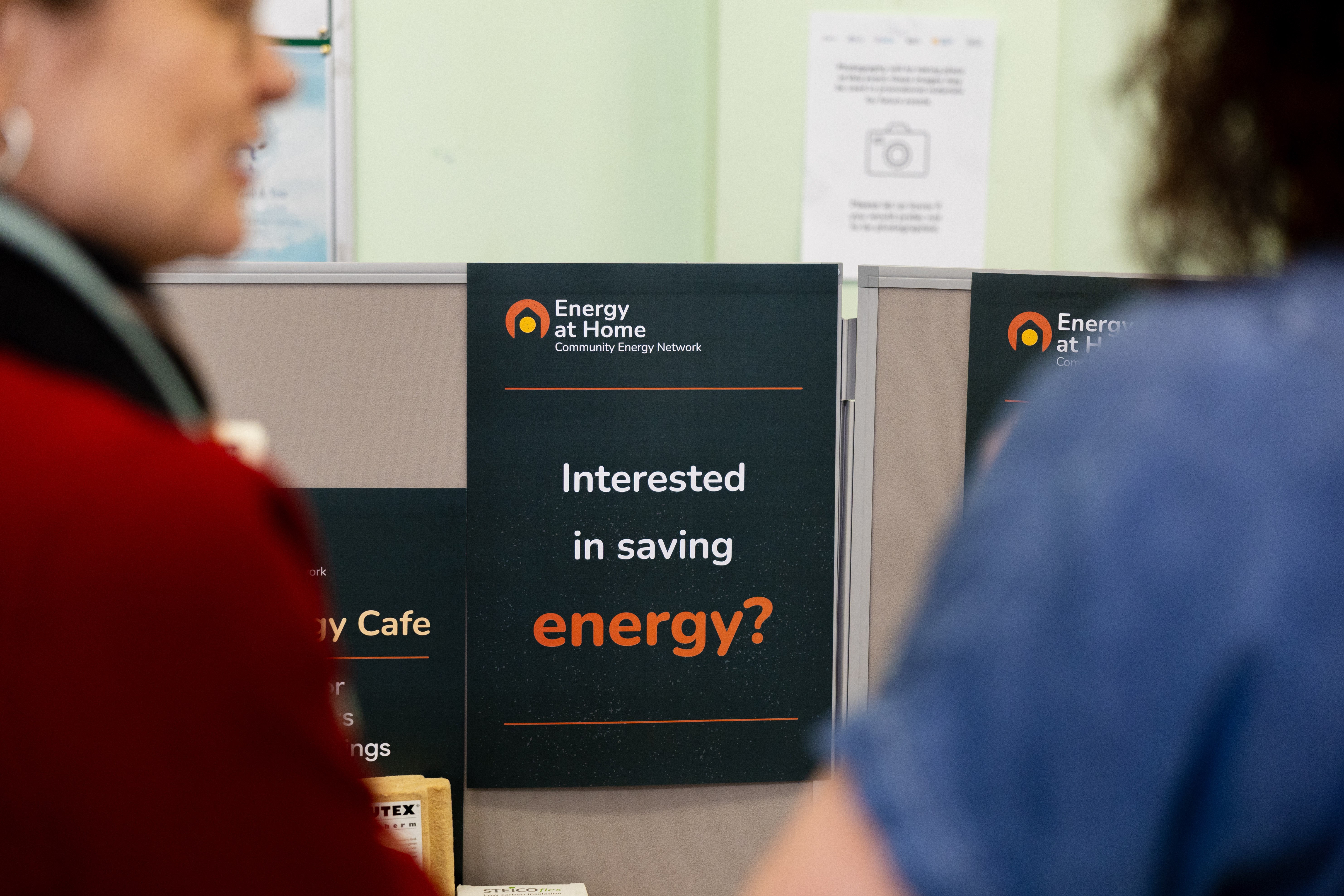 People browsing Energy At Home literature at a public event