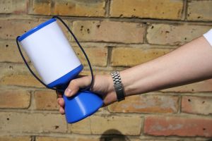 Photo of a hand holding a charity collection tin