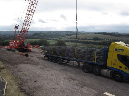 Reinforcing steel arriving on time this morning and being off-loaded by the crane