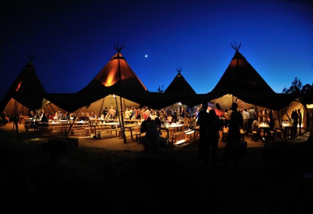 Wedding tents lit up outside at night