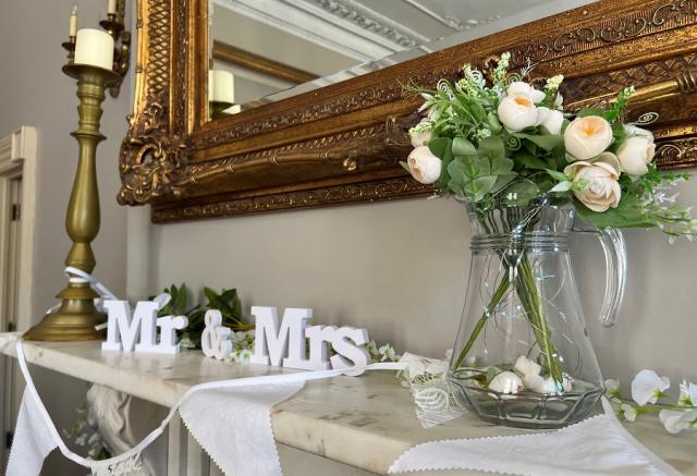 Mr and Mrs sign under large gold mirror