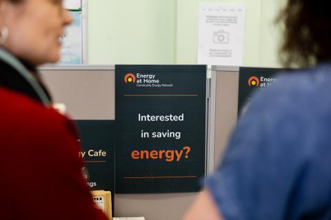 People browsing Energy At Home literature at a public event